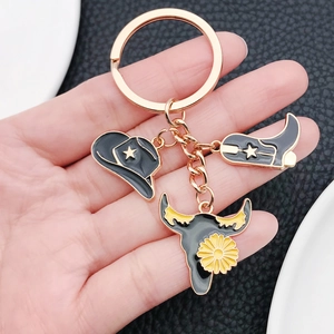 Western cowboy keychain set with enamel hat, boot and bull head charms on a gold ring