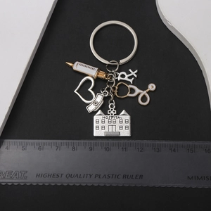 Antique silver medical keychain with stethoscope syringe and nurse hat charms
