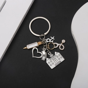 Medical themed keychain with syringe, stethoscope and heart pendants in silver finish