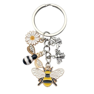Enamel bee and daisy keychain with silver-colored ring and rhinestones on white backdrop