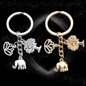 Antique silver and gold keychain with lotus flower, tree of life, and elephant pendants