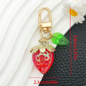 Detailed size view of the red strawberry keychain with green leaf and pink rhinestones