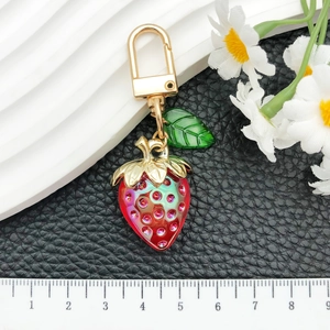 Cute red translucent strawberry keychain with sparkling rhinestones and gold leaf hook