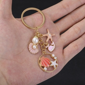Golden keychain with pink starfish, sea shell and whale pendants with white pearls