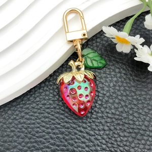 Cute strawberry bag charm with sparkling pink rhinestones and gold D-ring buckle