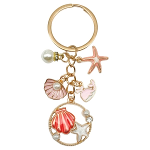 Pink starfish and whale ocean keychain with pearls and shells on gold metal hardware