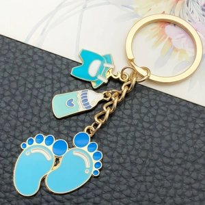 Porte-clés bébé avec pendentifs biberon rose et bleu, vêtements et empreintes de pieds