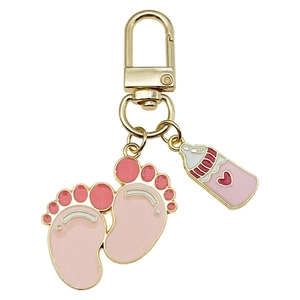 Pink baby feet and milk bottle keychain with gold plating on a clean white background