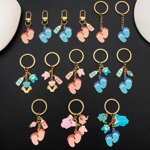 Cute baby feet and bottle enamel keychains in pink and blue for baby shower gifts