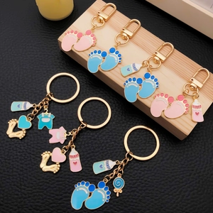 Cute baby-themed keychain with footprints and milk bottle pendants in pink and blue