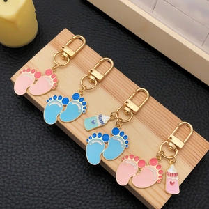 Cute baby footprints and milk bottle keychains in pink and blue enamel on wood