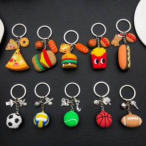 Flat lay of creative PVC keychains featuring fast food and various sports ball themes