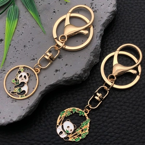 Detail of panda keychains with gold metal finish and enamel bamboo design on stone