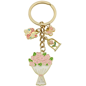Porte-clés MAMA doré avec bouquet de fleurs roses, papillon et breloques rose sur fond blanc