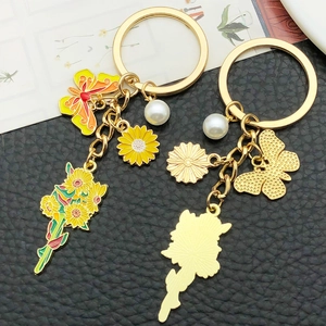 Golden butterfly and sunflower charms keychain with white pearl for women bags