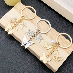 Elegant gold and silver hollow butterfly keychains with imitation pearl on wood base