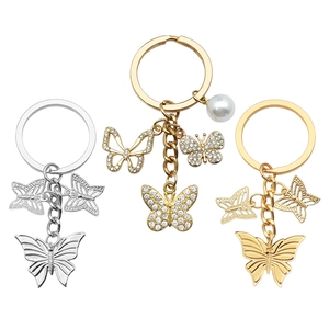 Elegant hollow butterfly keychain set with rhinestones and pearl charms in gold and silver