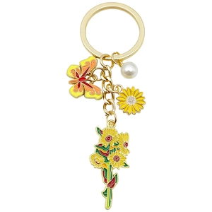 Golden butterfly and sunflower bouquet keychain with pearl accent on white background