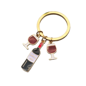 Creative wine themed keychain featuring gold metal bottle and glasses with red enamel finish