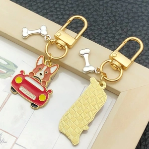 Cartoon corgi driving red car metal keychain with I Love Drive text and bone charm