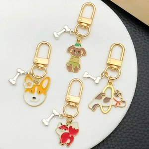 Cute cartoon enamel dog and fox keychain set with bone pendants on a white display tray