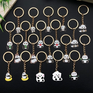 Cute cartoon panda keychains set with golden enamel finish on black leather background