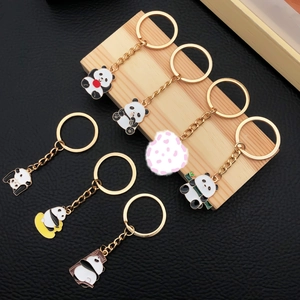 Cute panda enamel keychains in 7 poses with bamboo on wood and black leather