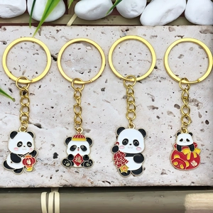Set of four cute cartoon panda keychains with traditional Chinese New Year festive elements