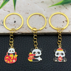 Detailed view of three enamel panda keychains with festive Chinese福 character charms