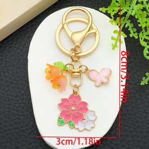 Porte-clés doré avec fleurs de cerisier roses et papillon en dégradé pour sacs
