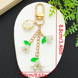 White lily of the valley acrylic flower keychain with green leaves and golden lobster clasp