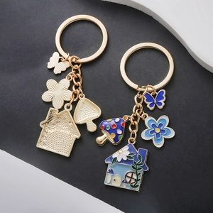 Creative blue floral and butterfly house keychain with enamel mushroom charms and gold finish