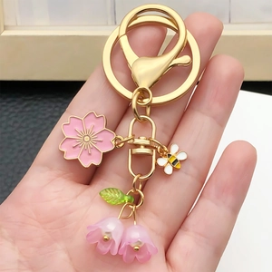 Kirschblüten- und Bienen-Schlüsselanhänger mit Maiglöckchen-Anhängern auf Goldring