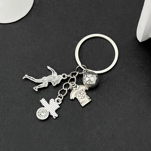 Silver soccer keychain featuring football player silhouette and jersey pendant charms