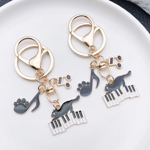 Cute black enamel piano cat metal keychain set with golden music note charms
