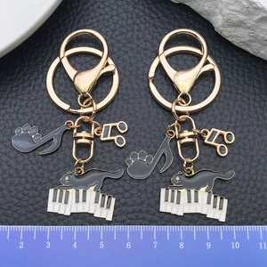 Cute black enamel piano cat keychain with musical notes on high-quality gold plating