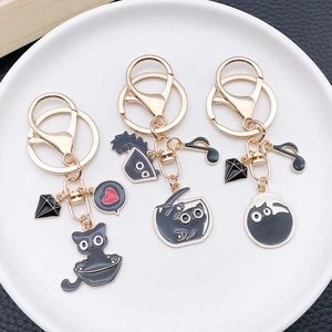 Three cute cartoon black cat keychains in gold finish alloy for creative bag decoration