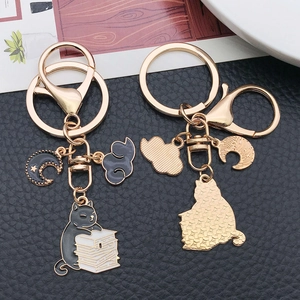 Cartoon black cat reading books keychain with gold zinc alloy accents for backpack charm