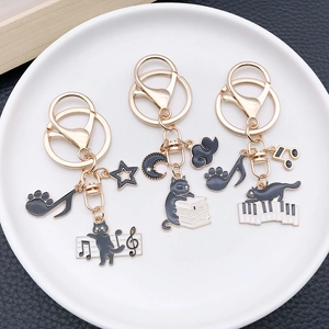Cartoon black cat metal keychain set with musical notes and piano keys in gold finish