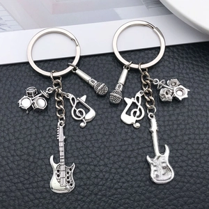 Vintage silver music keychain set featuring guitar drum and microphone charms for musicians