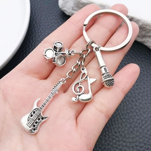 Antique silver musical keychain with guitar, drum, note, and microphone charms
