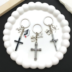 Detailed macro view of three gothic cross keychains with skull and bat charms