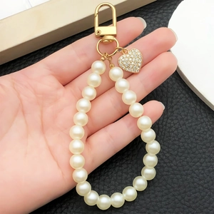 Handheld faux pearl wristlet keychain with golden heart pendant and D-ring clip