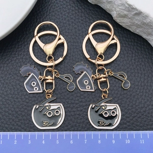 Golden cat keychain set with black enamel kitty charms and lobster clasp for bags
