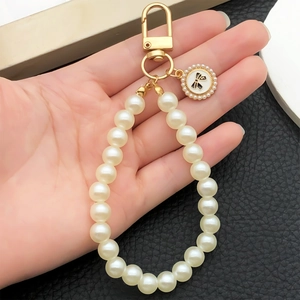 Creative pearl bow pendant keychain with gold clasp for handbag and key accessory