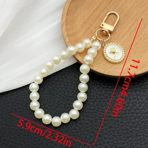 Detail of pearl keychain with gold rose pendant showing 11.7cm product dimensions