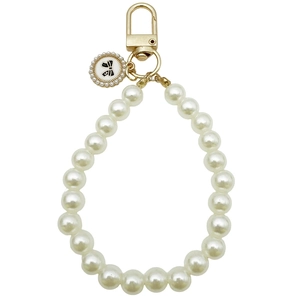 Faux pearl beaded keychain with gold D-ring and black-white bow charm with letter S