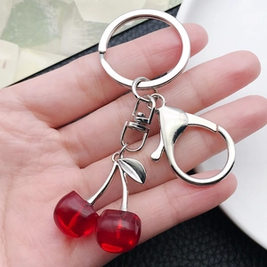 Creative translucent red cherry keychain with silver leaf and lobster clasp in hand