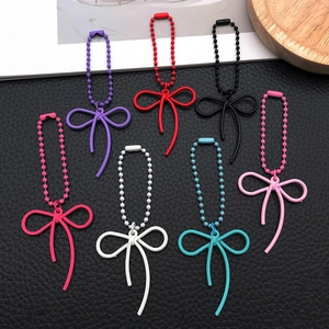Set of 7 colorful alloy bowknot pendants with ball chains for DIY phone cases and bags