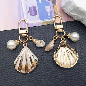 Nautical shell and conch keychain with pearl and gold scallop pendant on black leather